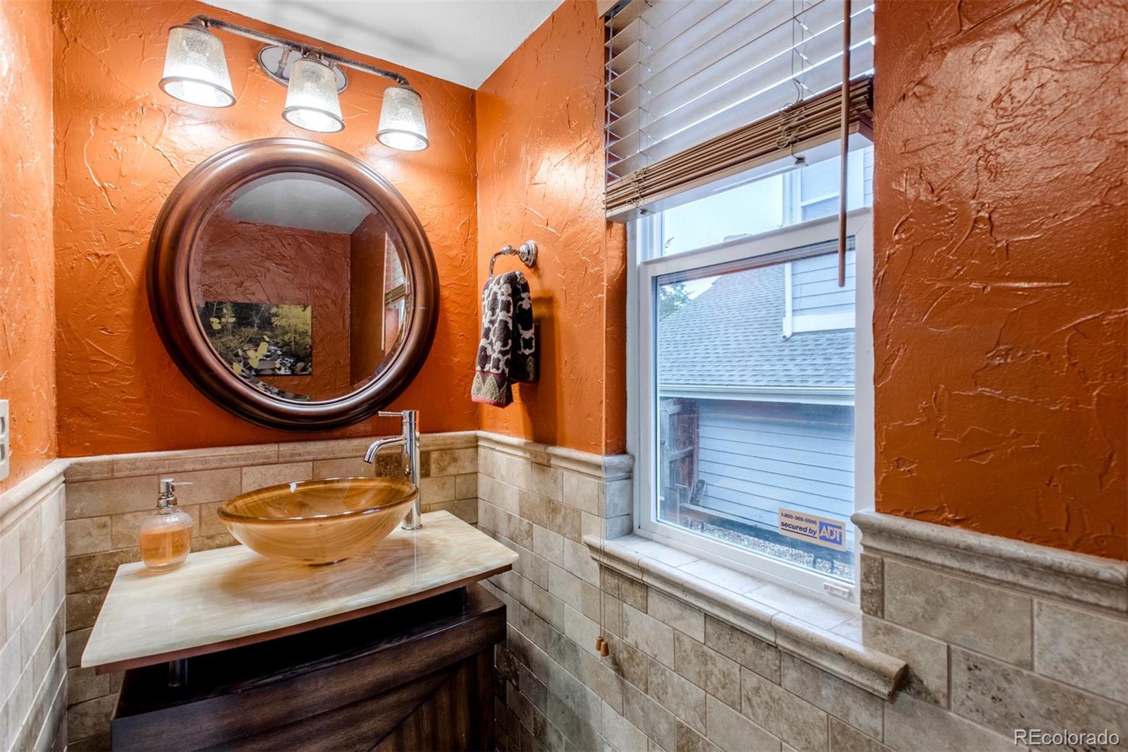 10037 Hooker Street Westminster, CO 80031 - Photo 15 of 40 a bathroom with a sink and a mirror