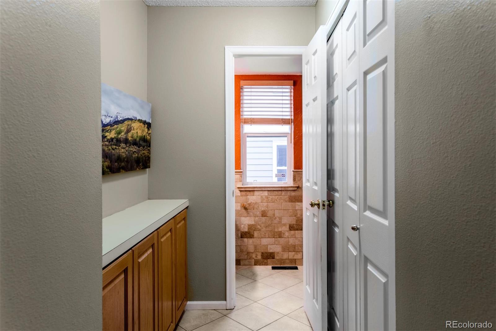 10037 Hooker Street Westminster, CO 80031 - Photo 16 of 40 a view of hallway with sink and a window