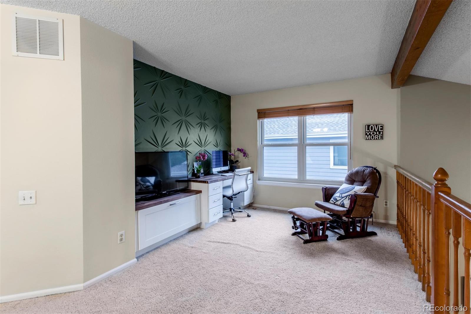 10037 Hooker Street Westminster, CO 80031 - Photo 17 of 40 a living room with furniture and a flat screen tv