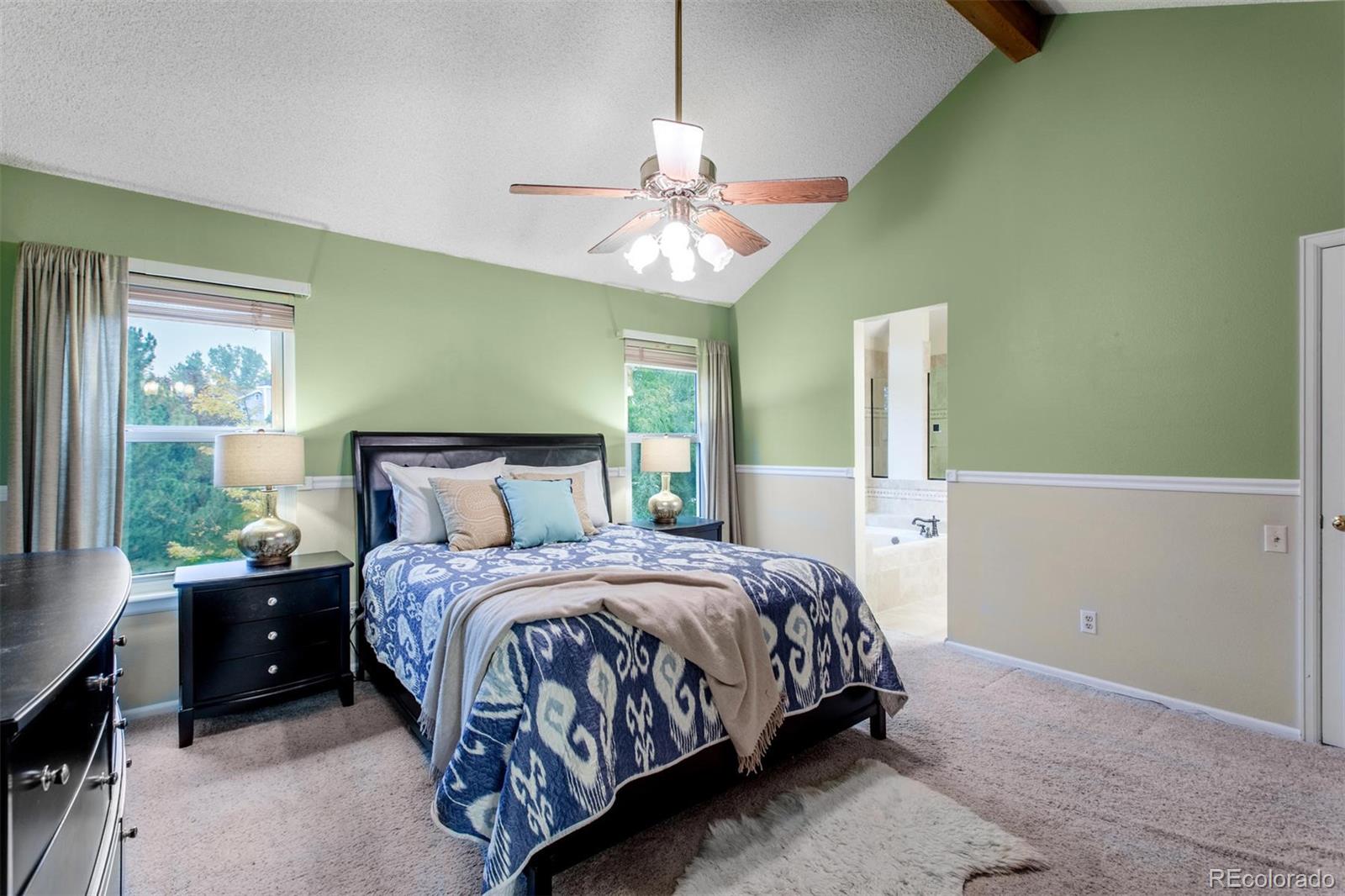 10037 Hooker Street Westminster, CO 80031 - Photo 18 of 40 a bedroom with a bed and a chandelier