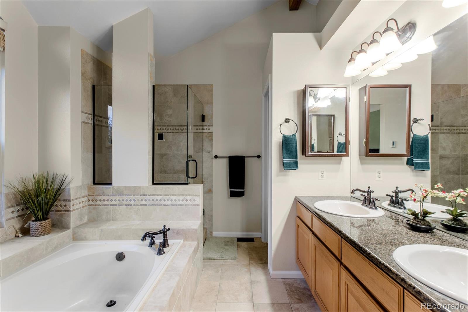10037 Hooker Street Westminster, CO 80031 - Photo 20 of 40 a bathroom with a tub sink and mirror
