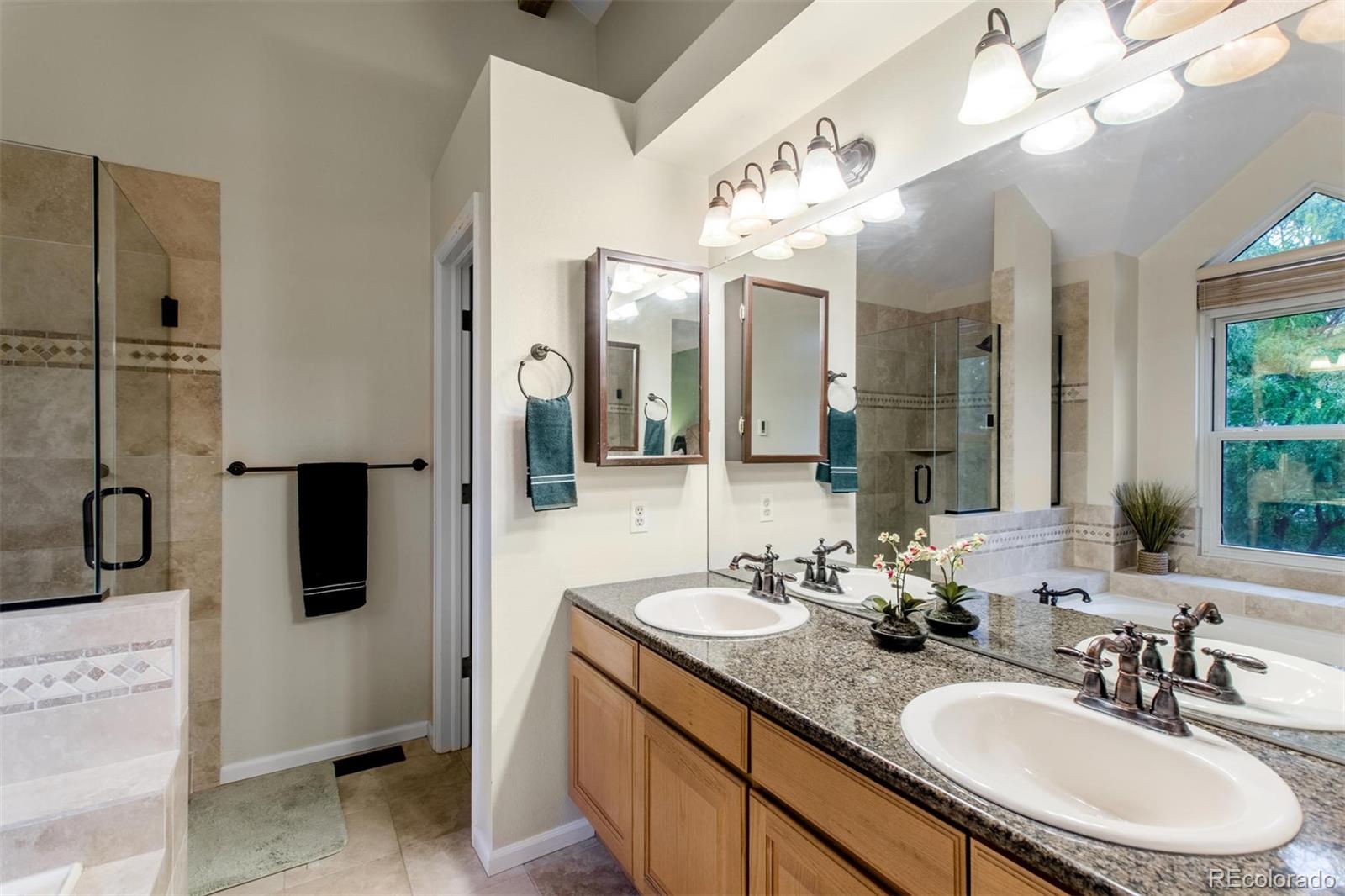 10037 Hooker Street Westminster, CO 80031 - Photo 21 of 40 a bathroom with a double vanity sink and a mirror