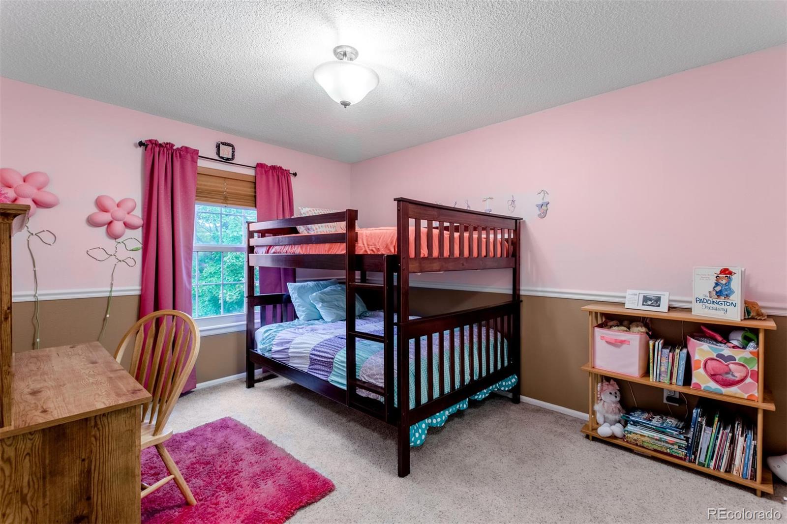 10037 Hooker Street Westminster, CO 80031 - Photo 24 of 40 a bedroom with furniture and a book shelf
