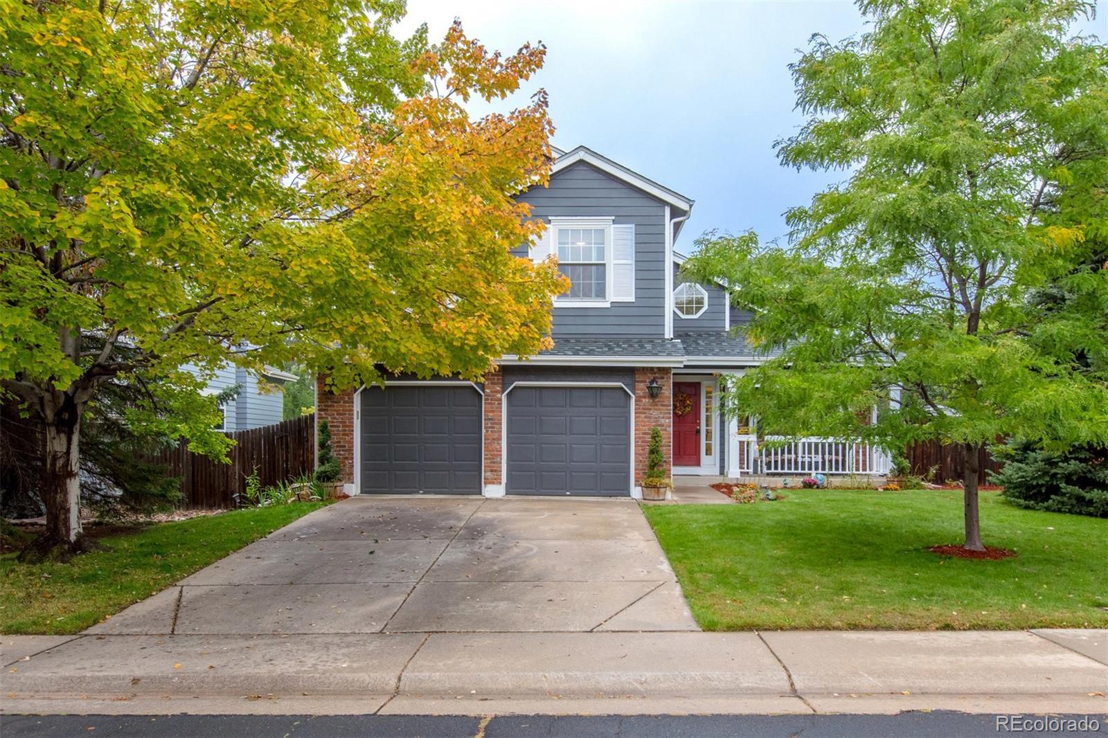 10037 Hooker Street Westminster, CO 80031 - Photo 25 of 40 a front view of a house with a yard and trees