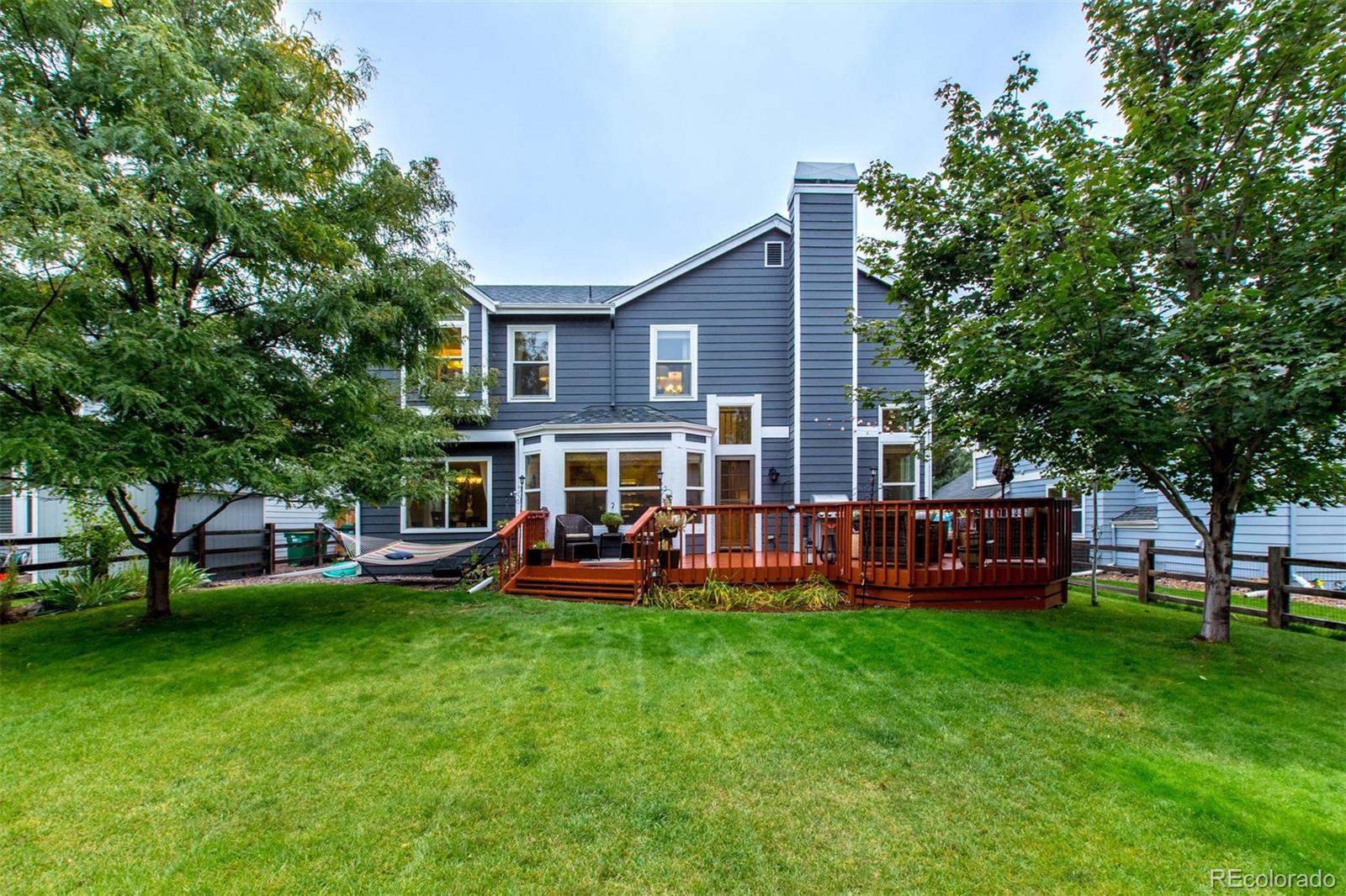 10037 Hooker Street Westminster, CO 80031 - Photo 26 of 40 a view of a house with a big yard and sitting area