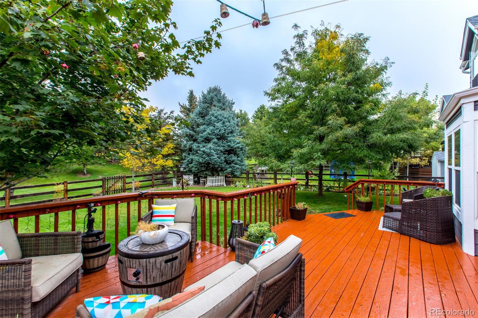10037 Hooker Street Westminster, CO 80031 - Photo 29 of 40 a view of a balcony with wooden floor and outdoor seating