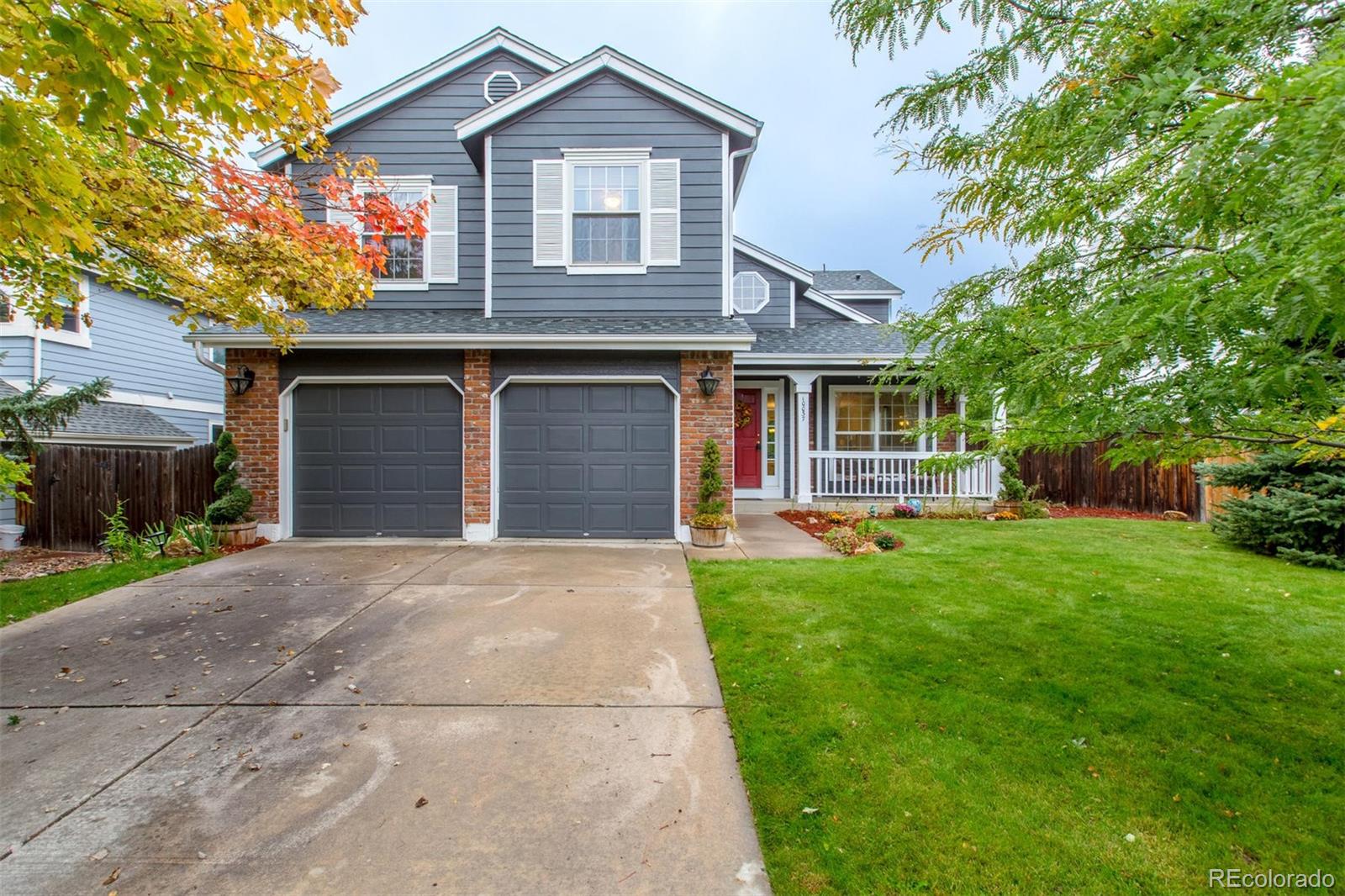 10037 Hooker Street Westminster, CO 80031 - Photo 3 of 40 a front view of a house with a yard and garage