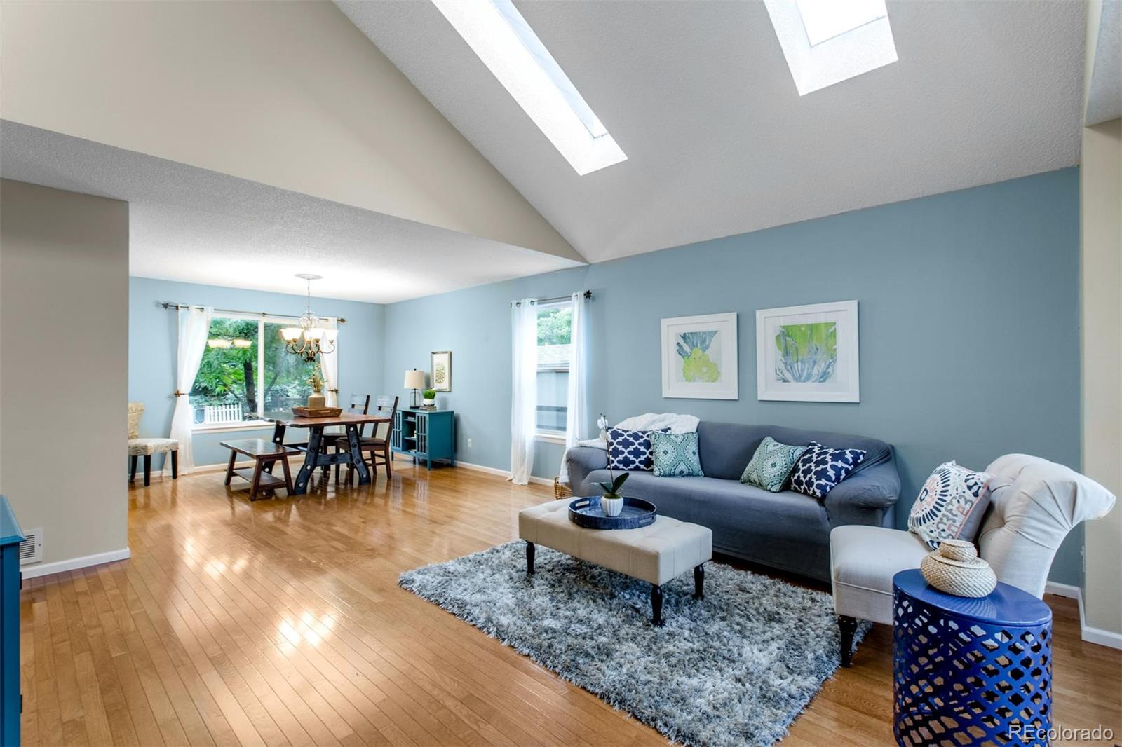 10037 Hooker Street Westminster, CO 80031 - Photo 4 of 40 a living room with furniture and a dining table with wooden floor