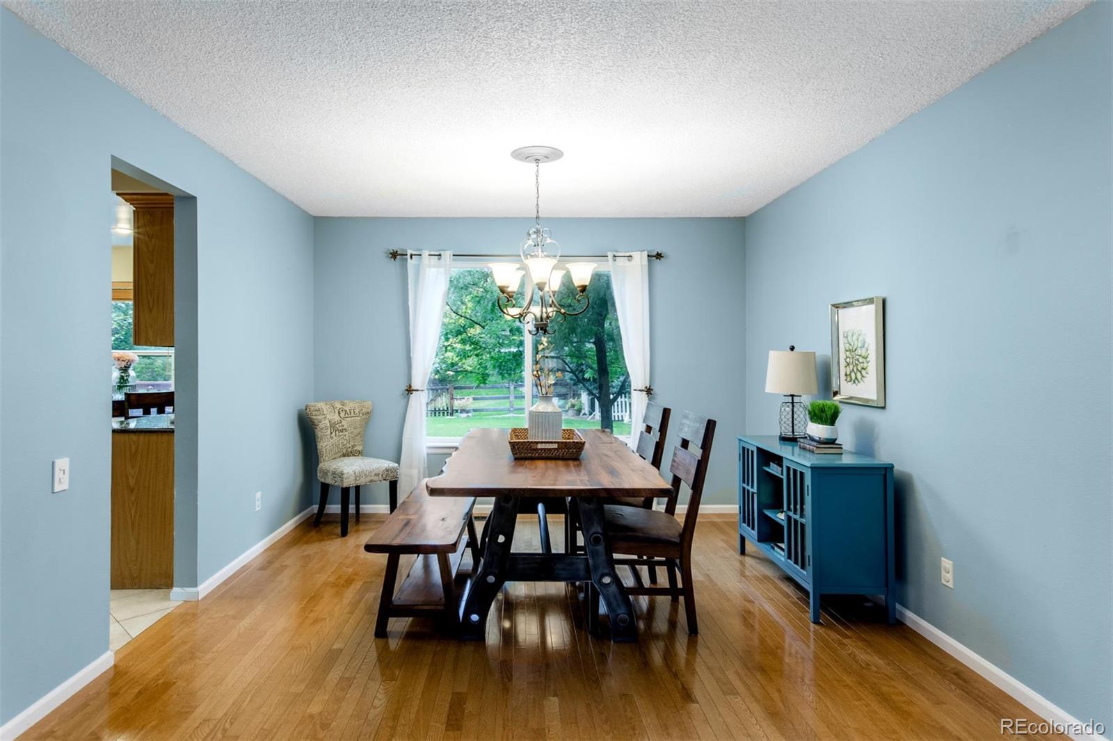 10037 Hooker Street Westminster, CO 80031 - Photo 7 of 40 a view of a dining room with furniture window and wooden floor