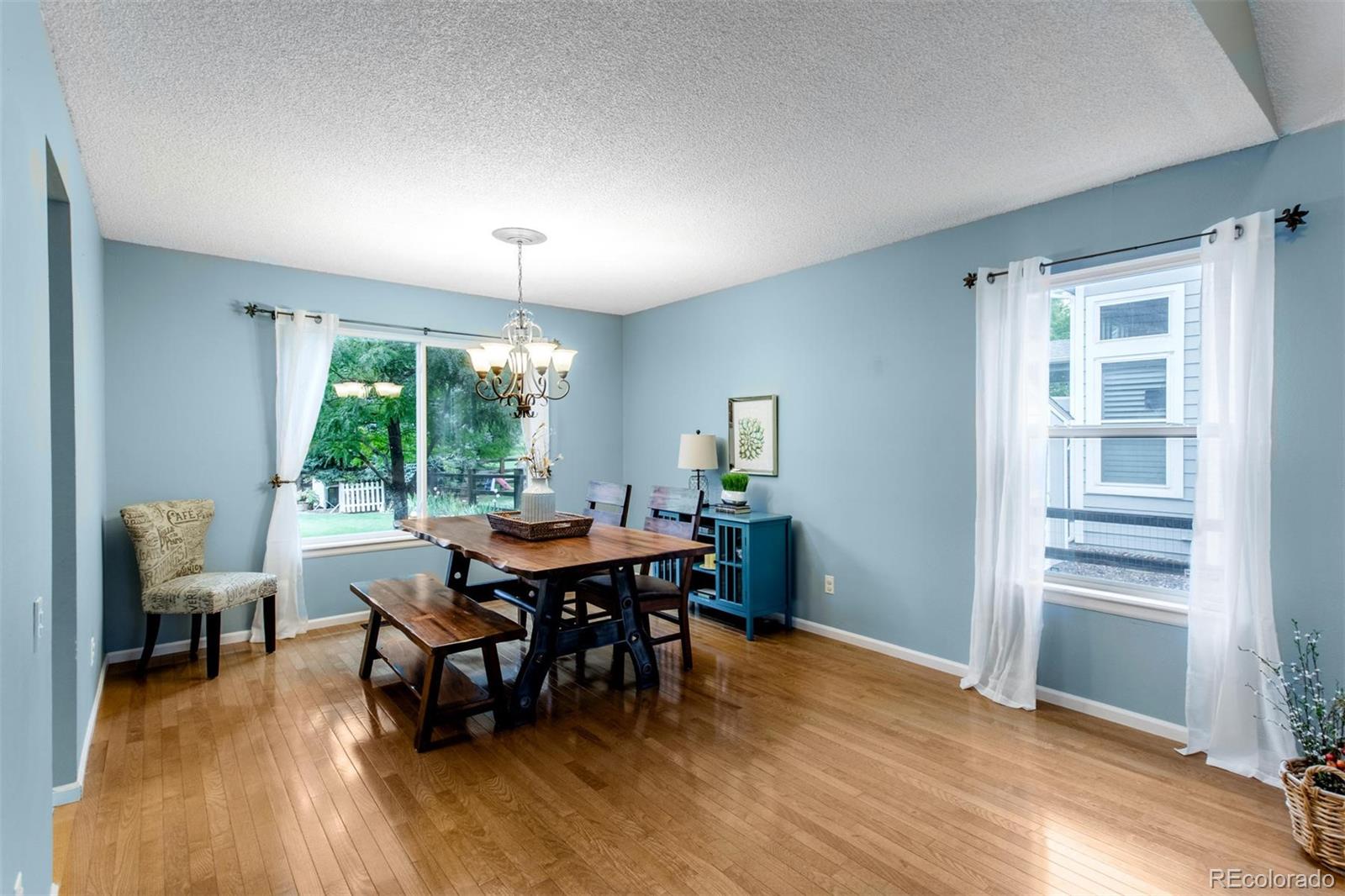 10037 Hooker Street Westminster, CO 80031 - Photo 8 of 40 a view of a dining room with furniture window and wooden floor