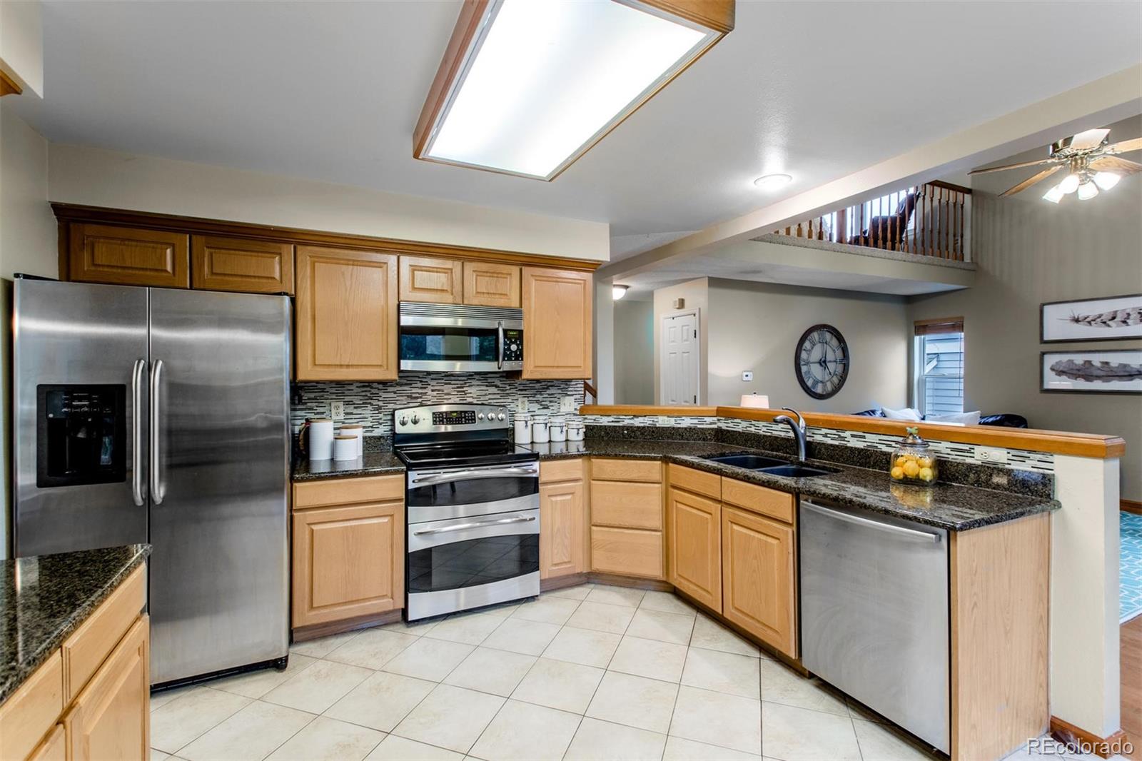 10037 Hooker Street Westminster, CO 80031 - Photo 10 of 40 a kitchen with a sink stove and refrigerator