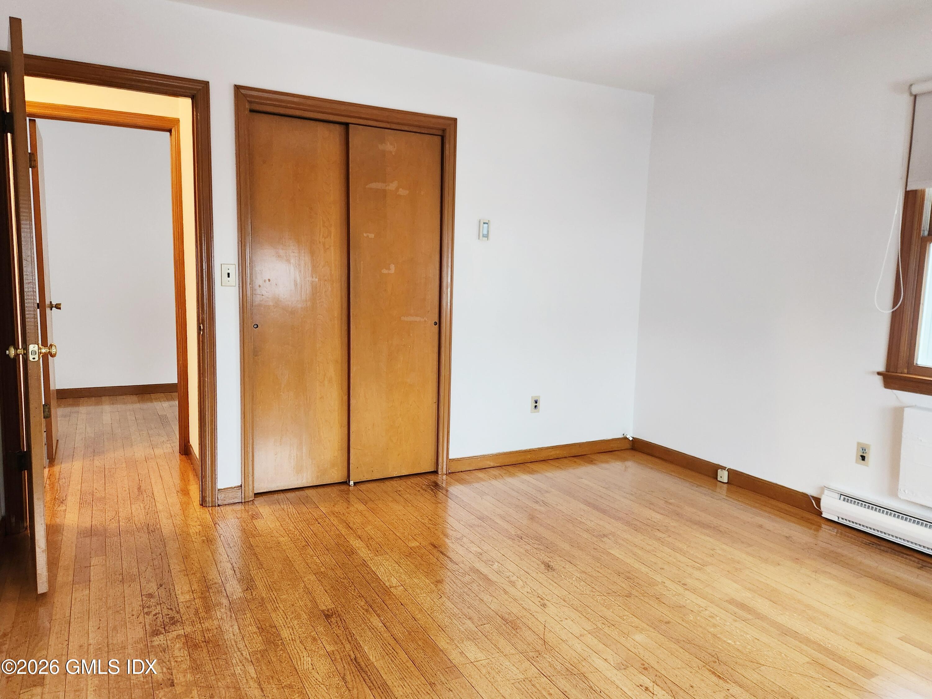 16 Harold Avenue, Unit B Greenwich, CT 06830 - Photo 9 of 17 an empty room with wooden floor and closet