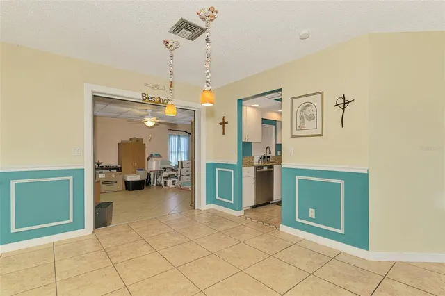 a kitchen with stainless steel appliances granite countertop a sink a stove and refrigerator