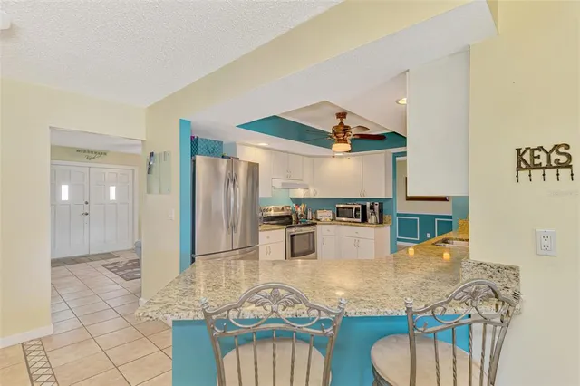 a view of a dining room with furniture and a chandelier