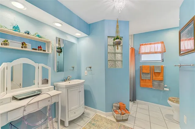 a living room with furniture a flat screen tv and a window