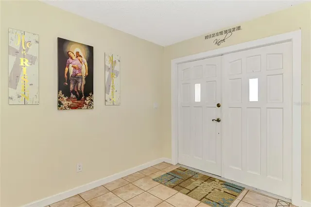 a living room with furniture a fireplace and a chandelier