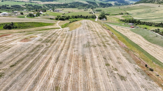 5588 East Glendale Road Preston, ID 83263 - Photo 5 of 11 Expansive agricultural field with visible crop rows