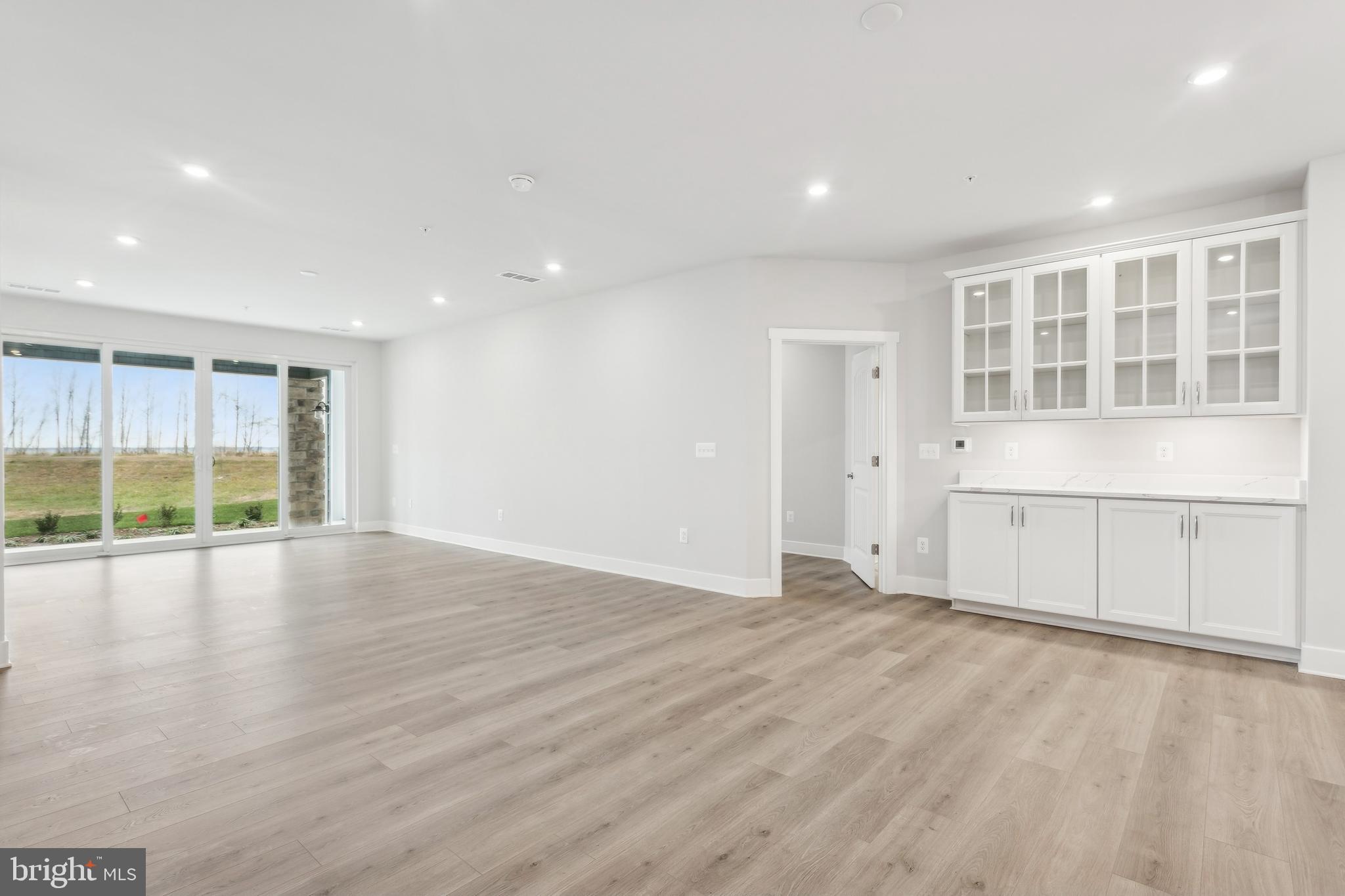 630 Warbler Way, Unit 2212 Chester, MD 21619 - Photo 7 of 73 a view of an empty room with a window and wooden floor