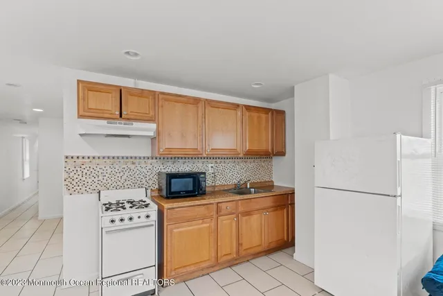 a bedroom with two beds and a potted plant