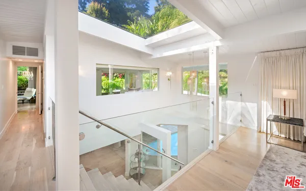 a view of an entryway with wooden floor and windows