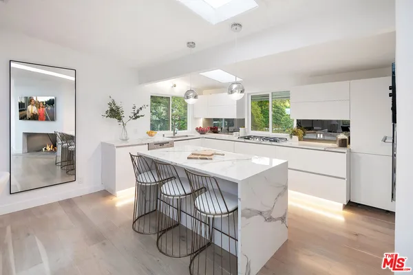 a kitchen with a table chairs and a refrigerator