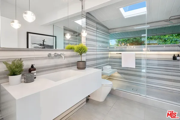 a bathroom with a sink and a large mirror