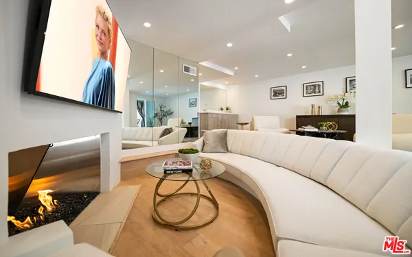 a living room with furniture a rug and white walls