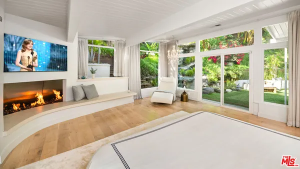 a bedroom with a large bed and a large window