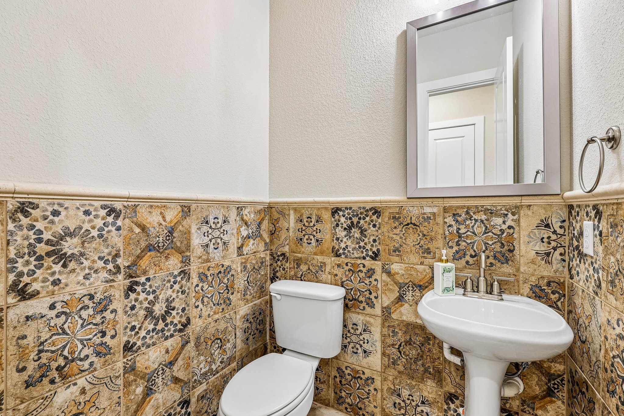 1705 Parten Rnch Parkway Austin, TX 78737 - Photo 11 of 39 Artfully patterned tiles enhance the character of this compact, well-appointed powder room.