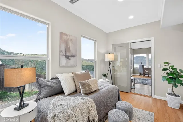 a bedroom with furniture and a wooden floor