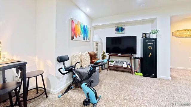 a view of a livingroom with furniture and a flat screen tv