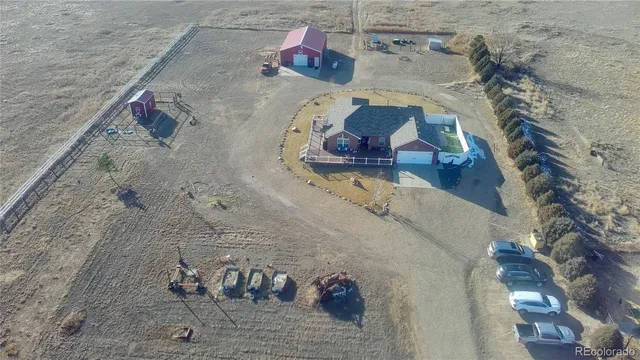 an aerial view of a house with a yard