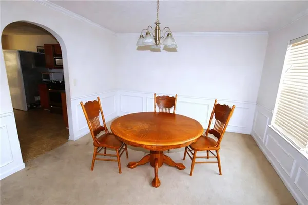 a dining room with furniture and window