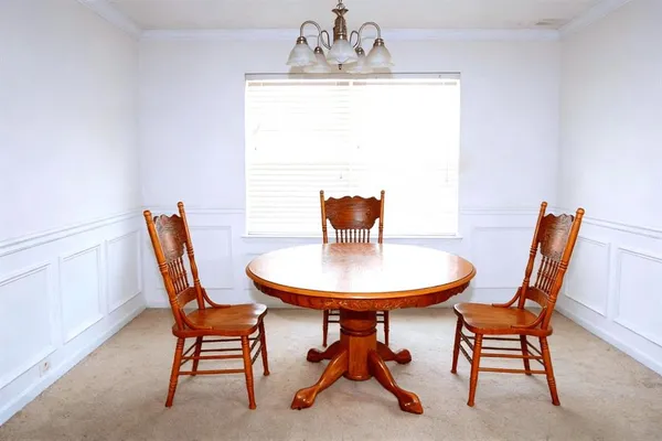 a view of a dining room with furniture and window