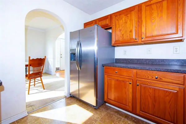a kitchen with stainless steel appliances granite countertop a refrigerator and cabinets