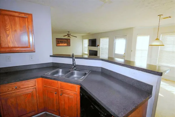 a kitchen with stainless steel appliances granite countertop a sink a stove and a granite counter top