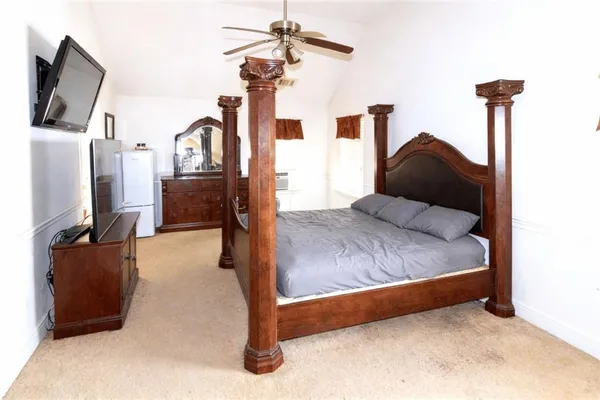 a bedroom with furniture and a flat screen tv