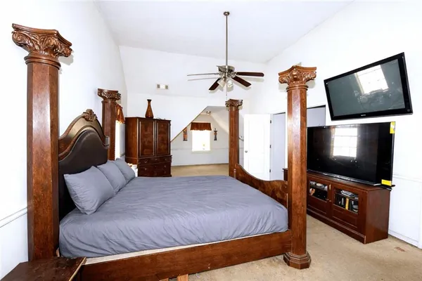 a bedroom with furniture and a flat screen tv