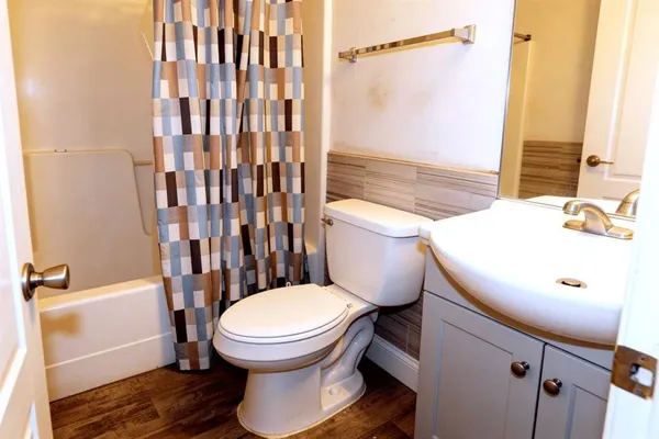 a bathroom with a sink toilet and shower