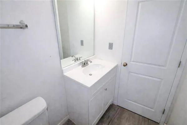 a bathroom with a sink toilet and vanity