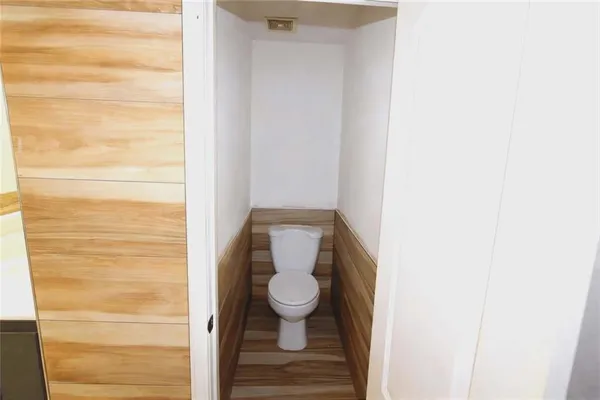a bathroom with a granite countertop toilet and a shower