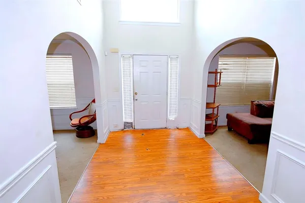 a spacious bedroom with a bed and a large mirror