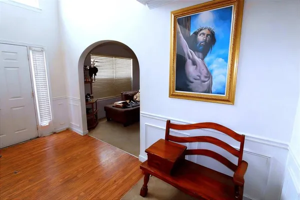 a bedroom with a bed and a painting on the wall