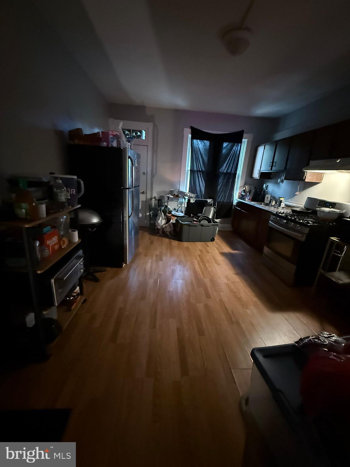 2117 Penrose Avenue Baltimore, MD 21223 - Photo 8 of 30 a living room with furniture flat screen tv and a fireplace