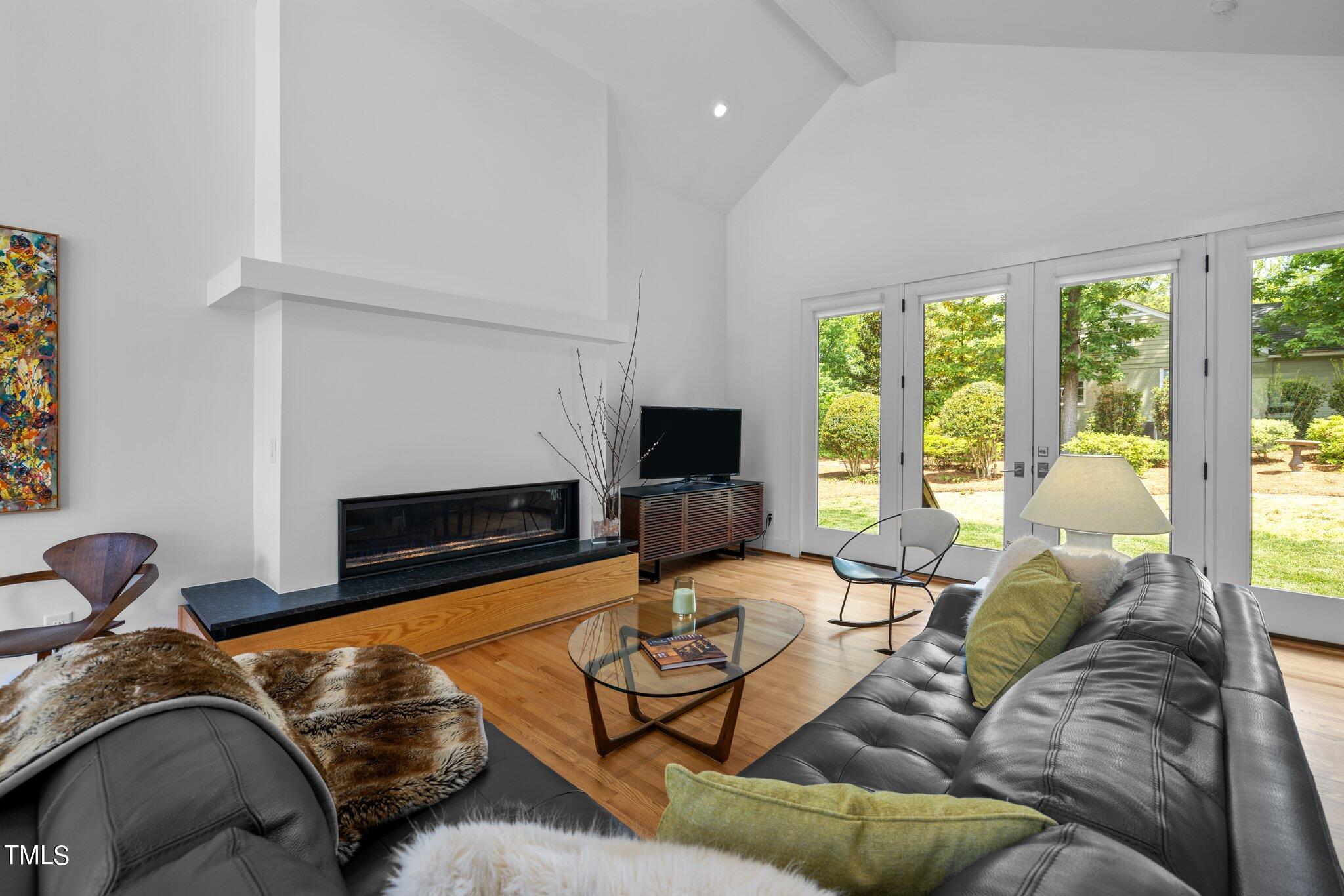 1110 Dogwood Lane Raleigh, NC 27607 - Photo 5 of 46 Enjoy the beautiful view of the backyard or cozy up to the linear gas fireplace