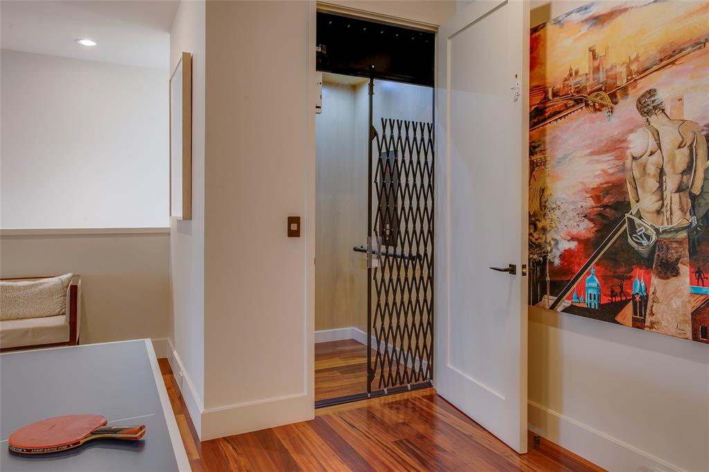 48 Ash Bluff Lane Dallas, TX 75248 - Photo 18 of 40 a view of a hallway with wooden floor and furniture