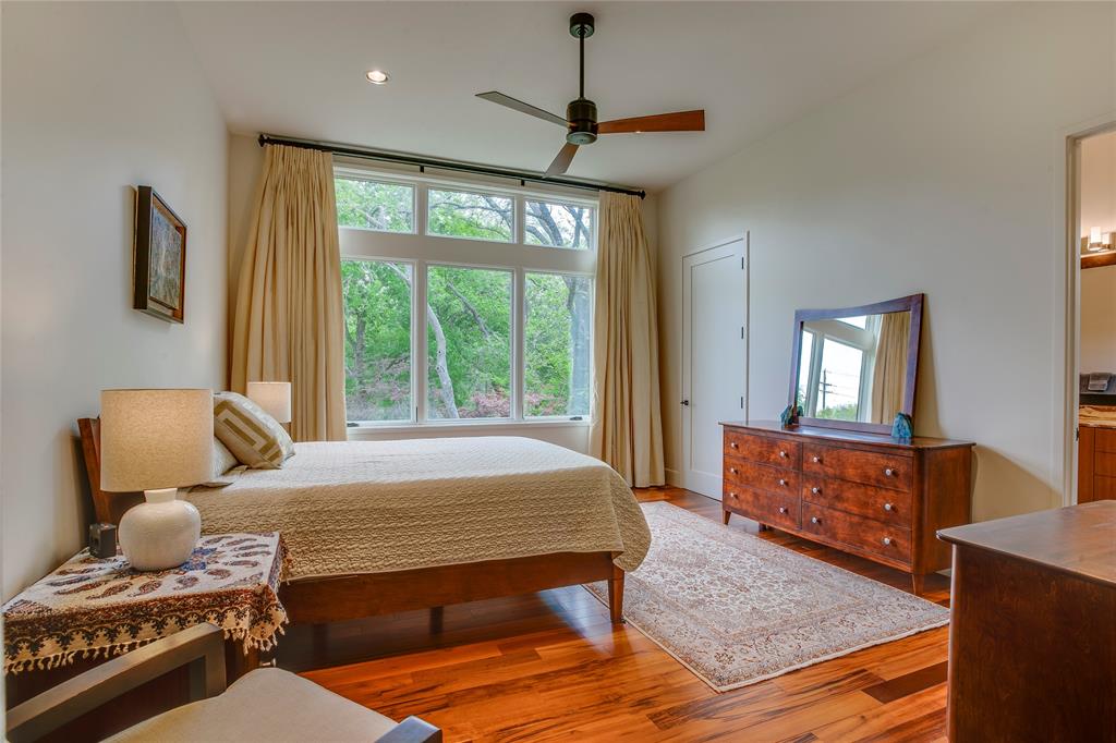 48 Ash Bluff Lane Dallas, TX 75248 - Photo 24 of 40 a bedroom with a bed and wooden floor