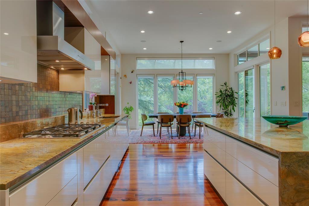 48 Ash Bluff Lane Dallas, TX 75248 - Photo 26 of 40 a kitchen with stainless steel appliances granite countertop a stove and a wooden floors