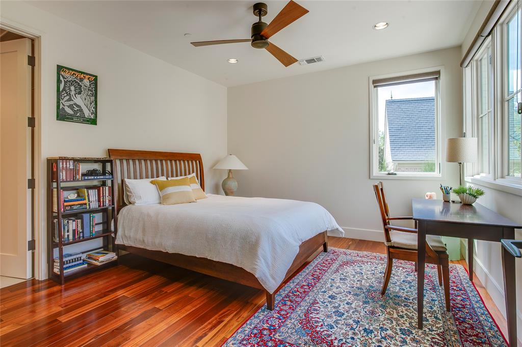 48 Ash Bluff Lane Dallas, TX 75248 - Photo 30 of 40 a bedroom with a bed a dresser and a book shelf