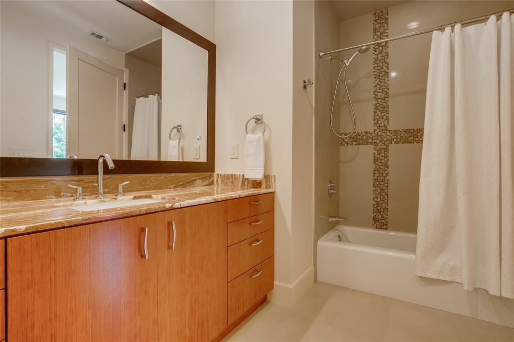 48 Ash Bluff Lane Dallas, TX 75248 - Photo 31 of 40 a bathroom with a granite countertop sink a mirror and a bathtub